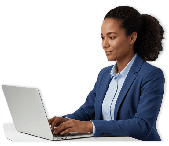 Woman in blue blazer working on a laptop at a desk.
